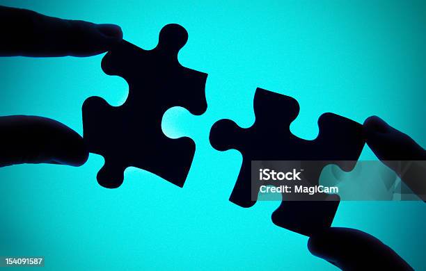 Connecting Two Pieces Of Puzzle Stock Photo - Download Image Now - Blue, Building - Activity, Business