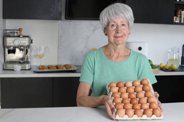 istock Senior woman many brown eggs 1540929916