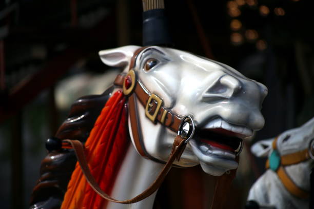 03/18/2015 Paris, France: Step into the whimsical world of Paris as you encounter a delightful scene captured in this picture. Nestled near the magnificent Sacré-Cœur Basilica, a famous carousel comes to life, adorned with vibrant lights and playful melodies. Amidst the enchanting carousel, a plastic horse stands proudly, its colorful coat catching the warm sunlight. As children's laughter fills the air, the horse patiently awaits its turn to carry young adventurers on a magical ride. With its intricate details and a touch of nostalgia, this carousel captures the essence of childhood wonder and joy. As you gaze at the plastic horse, you can't help but be transported to a place where dreams come true and imagination knows no bounds.