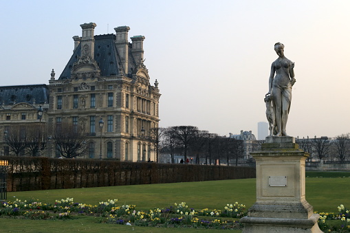 03/20/2015 Paris, France: In this mesmerizing image, we are transported to the grand exterior of the Louvre Museum in Paris, where a magnificent statue stands as a testament to artistic excellence. This awe-inspiring statue, positioned proudly outside the museum, exudes an air of grace and grandeur. Its intricate details and masterful craftsmanship showcase the skill and talent of the sculptor. As we gaze at the scene, we can't help but be enthralled by this remarkable piece of art. The statue's pose and expression evoke a sense of beauty and emotion, capturing the essence of the art housed within the museum's walls. This image serves as a captivating glimpse into the rich artistic heritage and timeless beauty that awaits visitors inside the Louvre Museum.