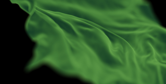 Green satin fabric flowing in wind with ripples