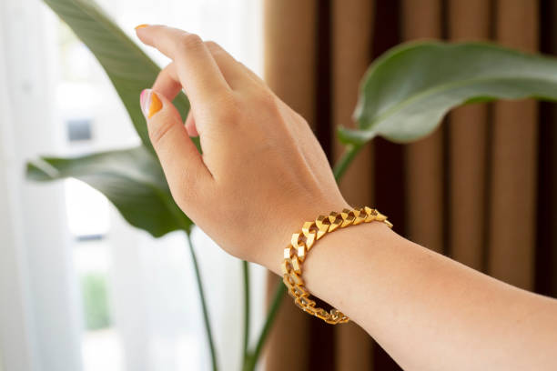 young woman wearing a gold bracelet - hand gold jewels bildbanksfoton och bilder