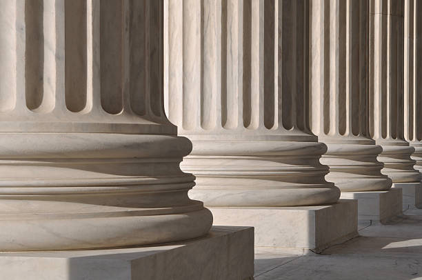 istock Line of marble pillars with sunlight coming trough 154099334