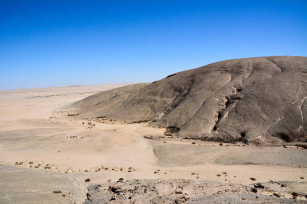 istock Rocky sloping deserted mountain in the desert. Environmental dehydration and global warming 1541001776