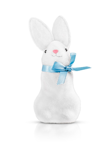 A toy white rabbit with artificial fur with a blue ribbon. highlighted on a white background