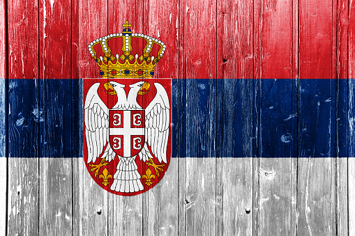 Flag of Serbia on a textured background. Concept collage.