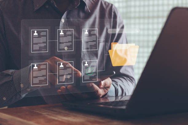 istock Document management system and network concept. Businessman use smartphone search for documents in online archives, Document management Storage and technology for digital document paperless operation. 1541121734