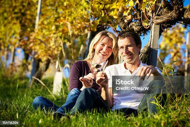 Couple Enjoying Wine In Vineyard Stock Photo - Download Image Now - Celebratory Toast, Vineyard, White Wine