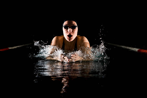 istock Professional swimmer breaststroke isolated black background 154116384