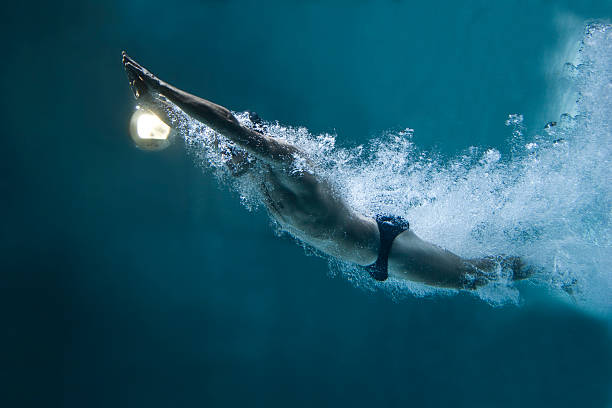 istock professional swimmer underwater after the jump 154116415