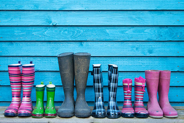 line of rubber boots line of rubber boots with different colors rubber boot stock pictures, royalty-free photos & images