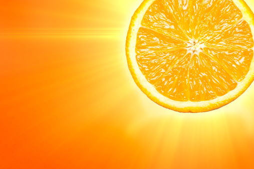 Glowing slice of orange on orange background