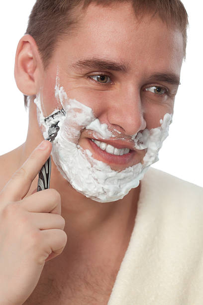 istock attractive man shaving his face 154128655