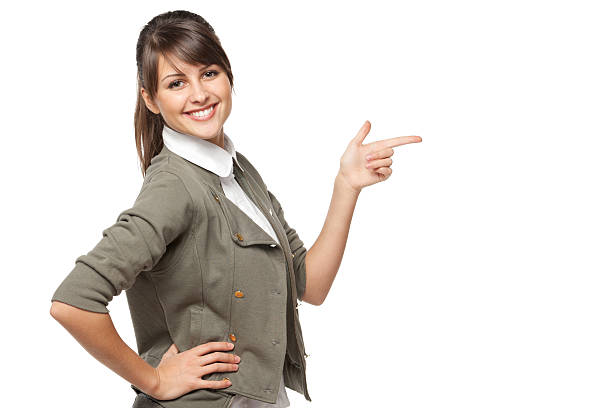Happy woman pointing to the side at copy space