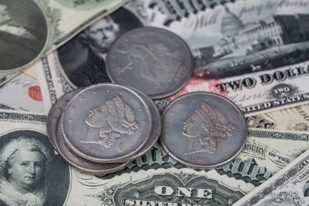 istock Old west US banknotes and silver certificates with silver dollar coins 1541355778