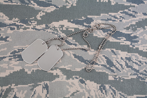 US AIR FORCE digital tiger-stripe pattern Airman Battle Uniform (ABU) with dog tags background
