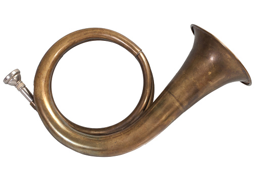 Vintage brass hunting horn isolated on a white background