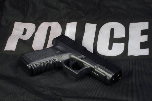 Police hand gun on black uniform
