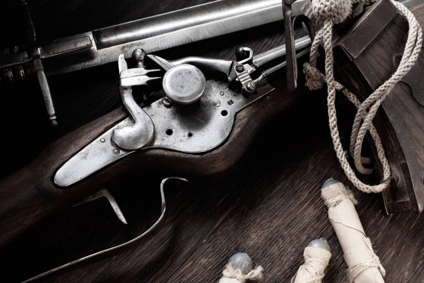 istock Flintlock musket with powder flask and led bullets. 1541366960