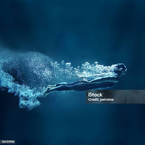 Female Swimmer Underwater Flowing On Blue Background Stock Photo - Download Image Now