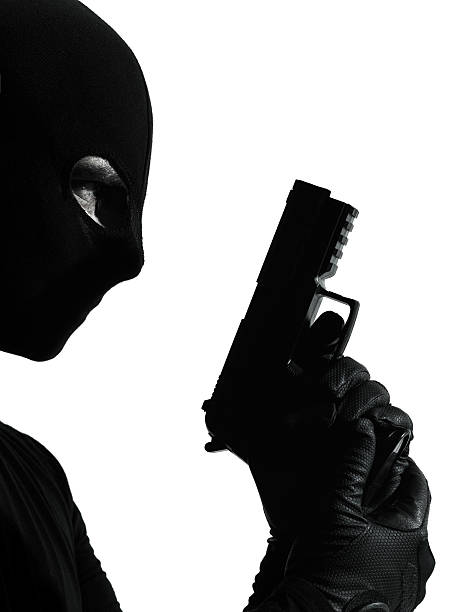 istock thief criminal terrorist holding gun portrait 154137993