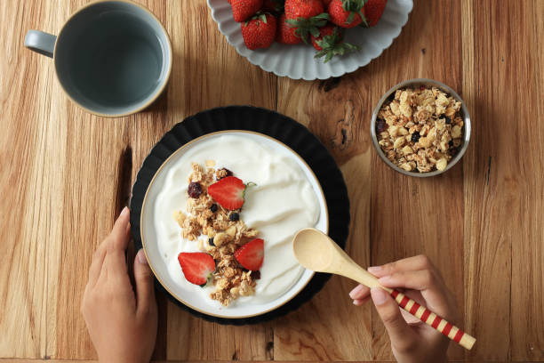 istock Eating Greek Yoghurt and Granola for Breakfast 1541384625
