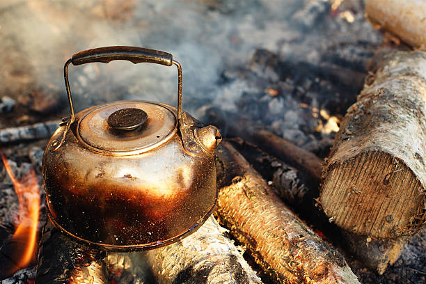 istock sooty teapot on camping bonfire 154140448