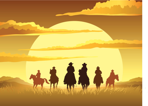 Team of cowboys silhouette galloping against a sunset background