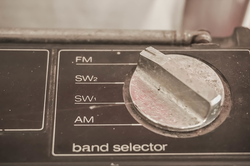 Selective focus photo of Silver Old Radio Stereo 2 Way 4 Speaker tape recorder radio FM AM band selector dial. Vintage, Unique, Rare collector item, collection, museum, old fashioned, cassette tape.