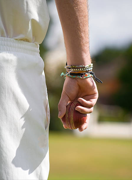 close-up of cricket player holding cricket ball