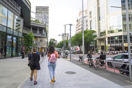 Tokyo, Japan - June 7, 2023: People and vehicles passing by and the atmosphere of the streets of Tokyo City when it's cloudy in summer.