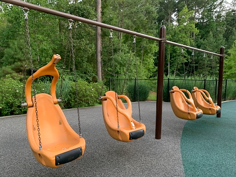 Accessible swings at inclusive playground in Raleigh NC.