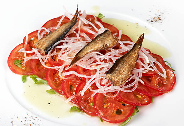Salad of Sardine, tomatoes, and onions stock photo