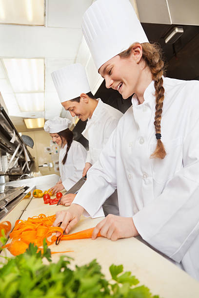 istock Row of chefs working hard in a restaurant commercial kitchen 154152660