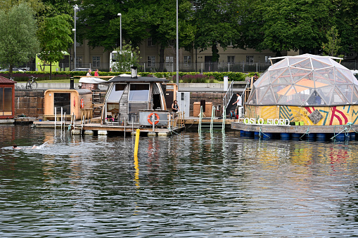 Oslo, Norway, July 6, 2023 - Oslo's floating saunas in the harbor near the opera house.