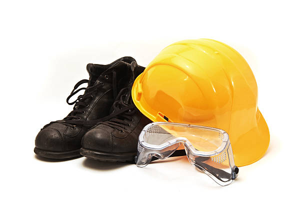 istock Yellow hard hat, old leather boots and protective goggles 154161111