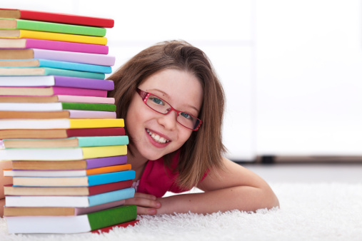 Young student with lots of books - happy and smiling