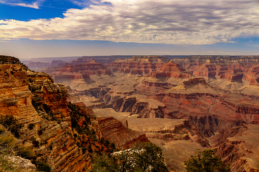 The vibrant layers, ranging in colors from deep reds and oranges to subtle shades of gray, offer a visual timeline showcasing the forces of nature that shaped the region over millions of years. The South Rim, Grand Canyon National Park, Arizona.