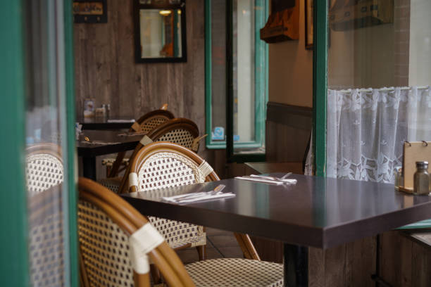 istock Empty seats through the open window of a cafe in Old Montreal. 1541626565