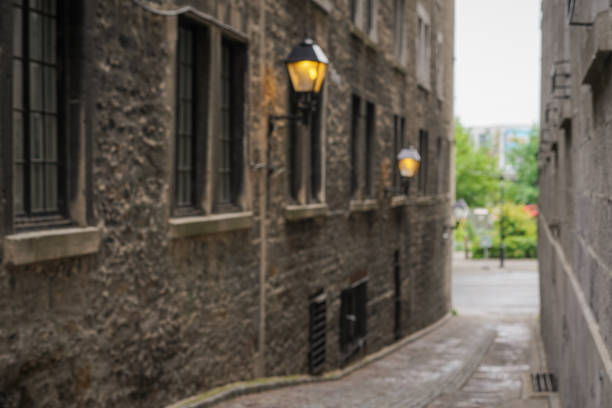 Defocused view down an alley in Old Montreal looking out at a park. Shot in the morning in early summer.