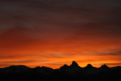 The sky lights up behind the west slope of the Teton Range.