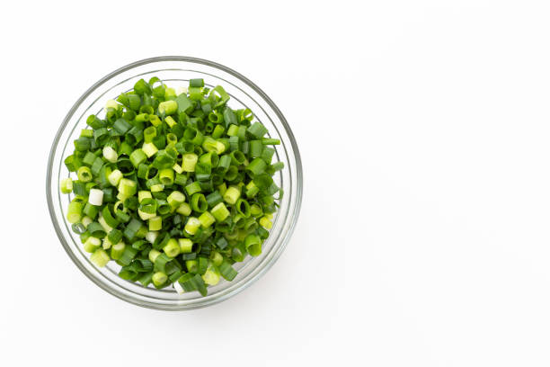 Chopped green onions on a white background.
