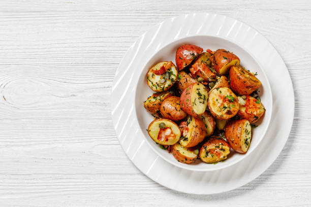 istock Herbs Garlic Potatoes in white bowl, top view 1541781072