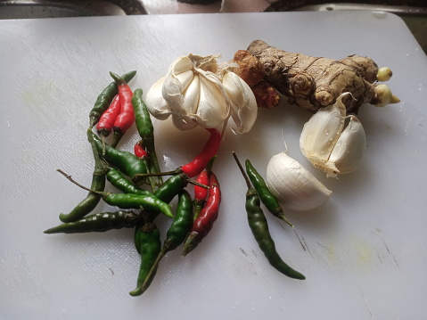 vegetables and spices on a kitchen table in the home kitchen. photo taken in malaysia
