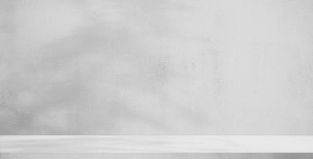 istock background and concrete backdrop and cement shelf showing products in black and gray , empty studio interior and with empty messages background. 1541865701