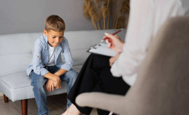 Professional child psychologist working with a schoolboy in a bright office. Children's mental therapy Professional child psychologist working with a schoolboy in a bright office. Children's mental therapy concept animal behavior stock pictures, royalty-free photos & images