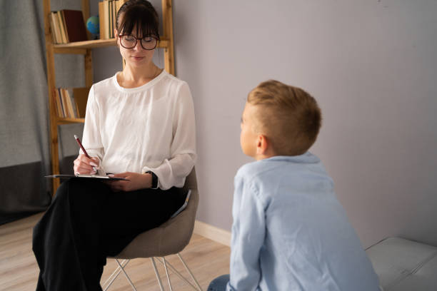 istock Professional child psychologist working with boy at office 1541868727