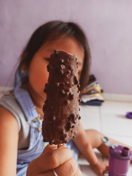 Little girl holding ice cream.