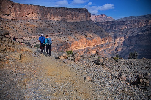 Senior couple hiking along the Grand Canyon in Jabal Shams, Oman