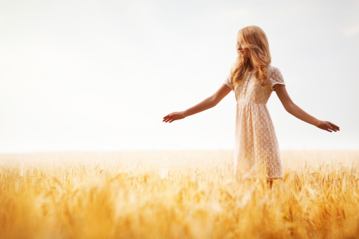 Beautiful blond girl at the wheat field